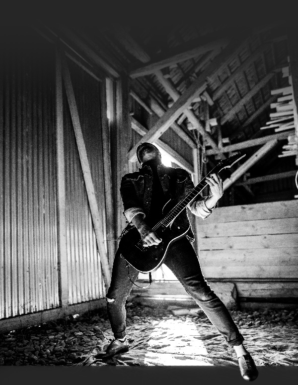 Guitarist Jamming in a Barn